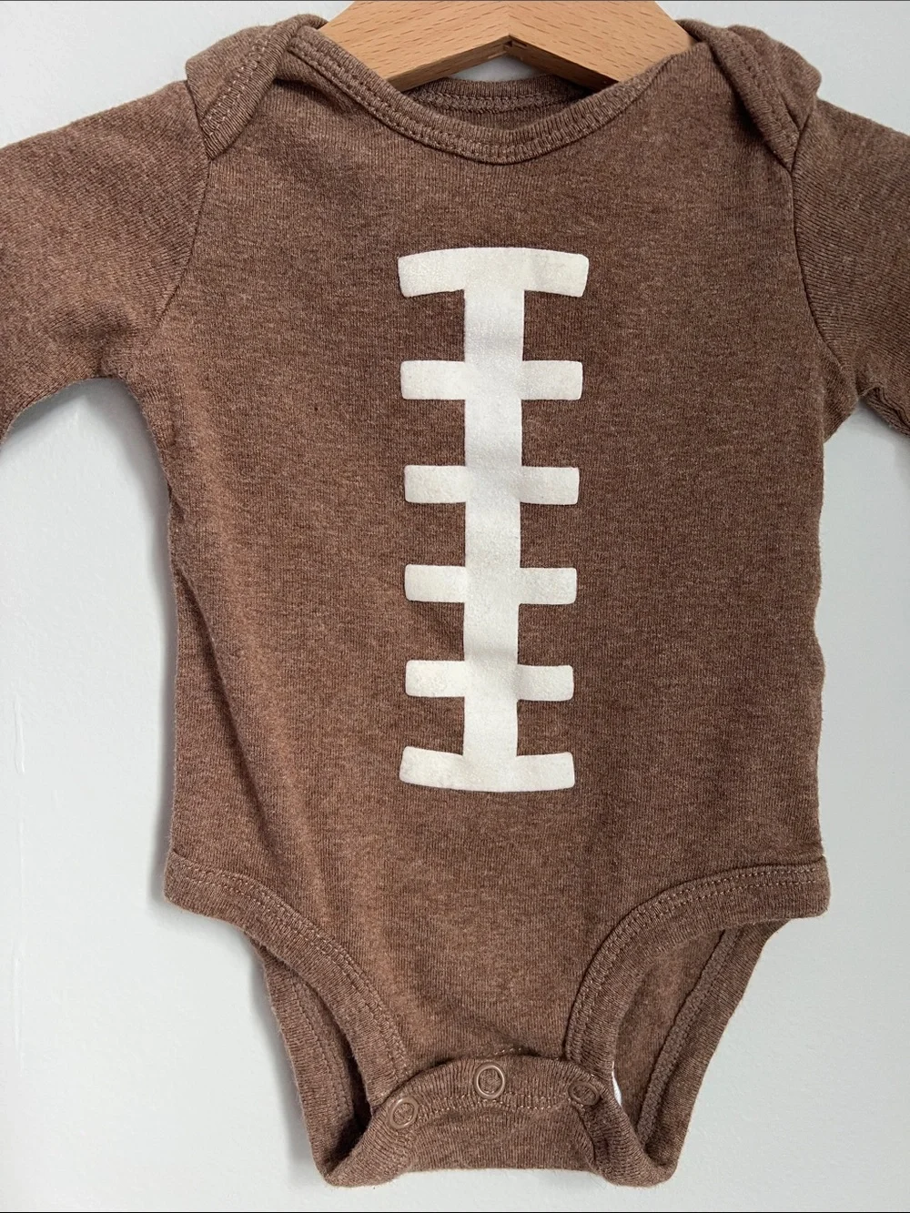 Carter’s | Brown Football-Stitch Long-Sleeve Baby One-Piece Size 3 Months